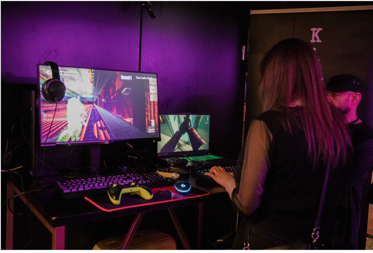 Gaming setup in a purple-lit room.